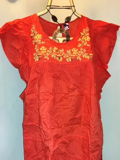 A summer special for my plus-size clients. This is a soft orange cotton top with beautiful hand-embroidered cross-stitch roses. My tops go up to size 6XL (UK 20) because style should be accessible to everyone.