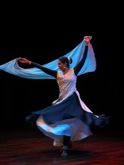 A dancer performs a swirling Kathak piece during the "Parabola of Dance" event. This series, curated by Aditi Mangaldas, explores both performance and the creative process behind it.