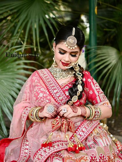 A happy bride-to-be posing in our red and pink multi-color lehenga. This photo captures the joy and beauty of a pre-wedding shoot.