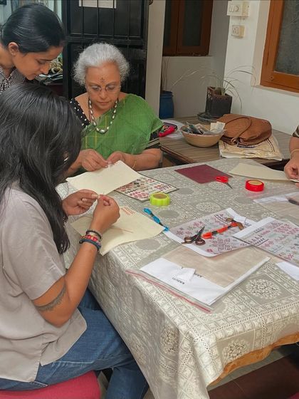 A Kasuti workshop in progress. I am helping a student with her pattern while another works diligently on her piece.
