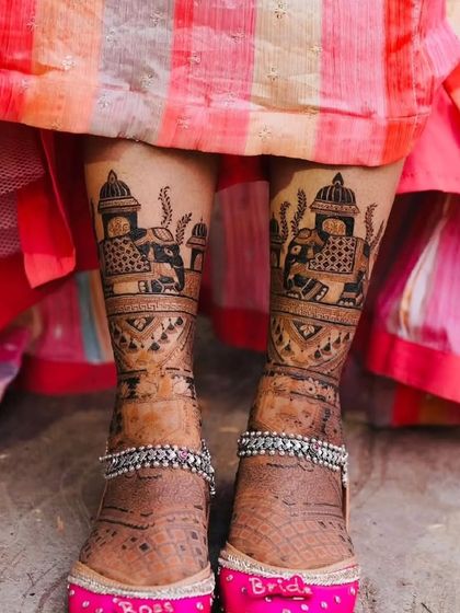 Bridal feet mehandi paired with custom "Bride" juttis. This photo shows how our designs complement your entire bridal look, right down to the shoes.