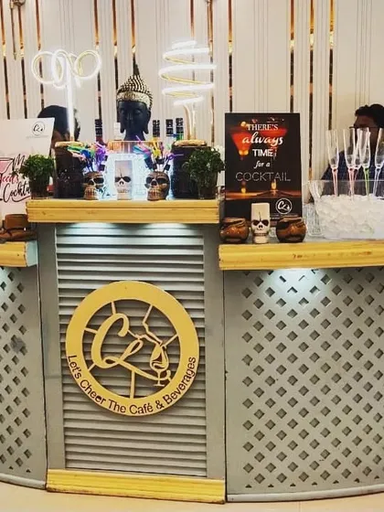 A sleek and modern Sangeet party setup. The custom branding on the bar and the neon lights create a sophisticated and trendy atmosphere.