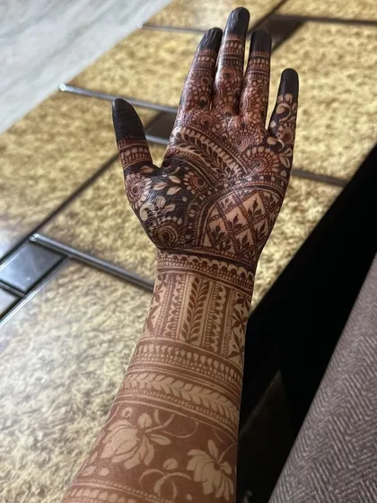 The back of a hand with a stained design, showing the beautiful color and detail.