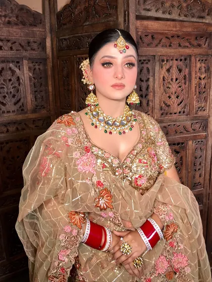 Another angle of the bride, showing the intricate details of her lehenga and jewelry.