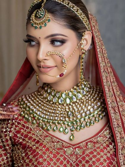 A side profile that highlights the beautiful contouring and the stunning details of her nose ring and earrings.