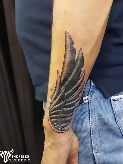 A single, detailed wing on the forearm. This tattoo can symbolize freedom, protection, or the memory of a loved one.