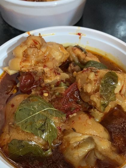 A bowl of my chicken curry, packed and ready for an order.