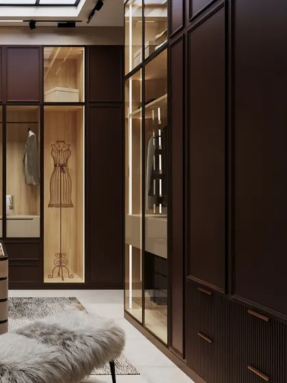 The wardrobe includes display niches, like this one with a mannequin, adding a touch of high-fashion boutique styling to the personal space.