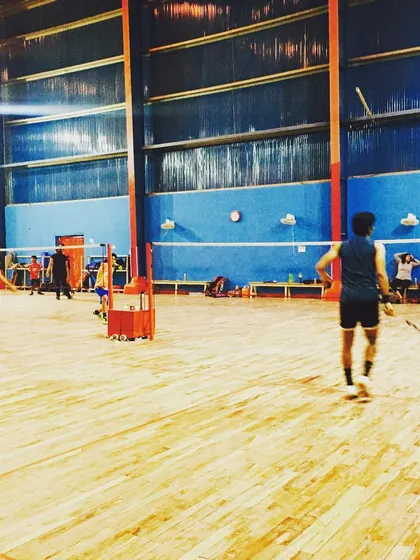 Players during a group coaching session on our expansive wooden courts. The atmosphere is focused and energetic, fostering both individual skill and a strong team spirit.