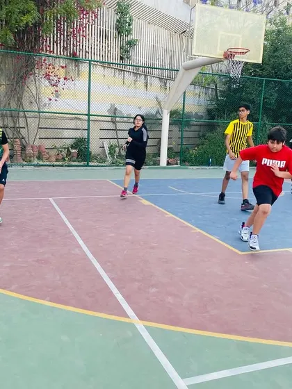 A young player dribbles the ball up the court, learning to lead the offense.