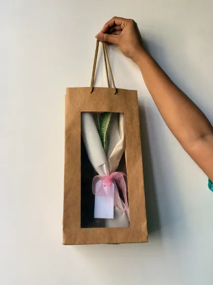 I make sure every order is packed beautifully and ready for gifting. This bouquet is all snug in its gift bag, waiting to make someone's day special.