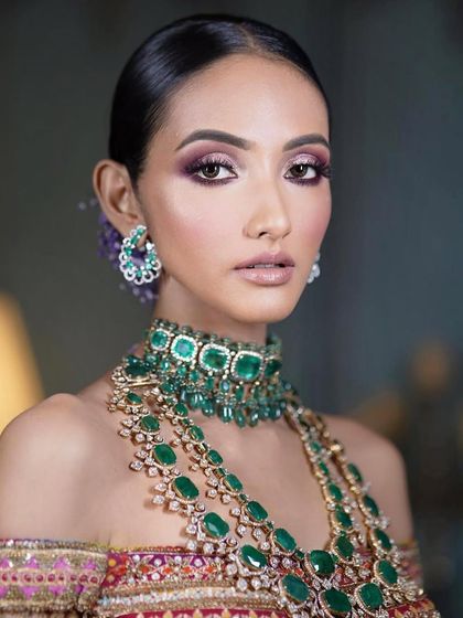 A close-up of a modern bridal look with a purple smokey eye. The makeup is glamorous and sophisticated, perfect for a bride who wants a touch of drama.