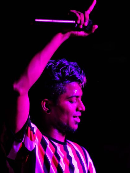 A candid shot under the pink stage lights from the AJIET fest. This is me in the zone, feeling the music and getting ready to drop the next track for the crowd.