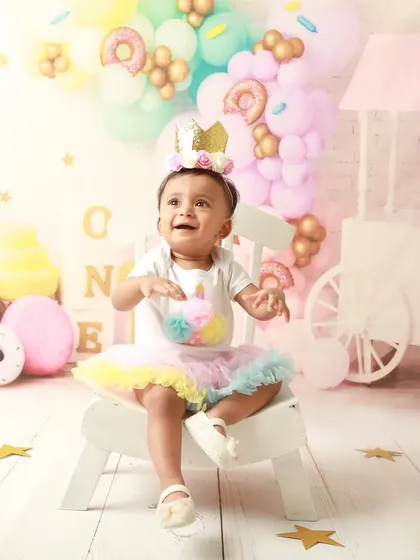 A happy smile from the birthday princess in her colorful, sweet-filled wonderland.