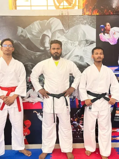 Standing with my senior karate students. As a coach, my job is to guide them on their path from beginner to black belt and beyond.