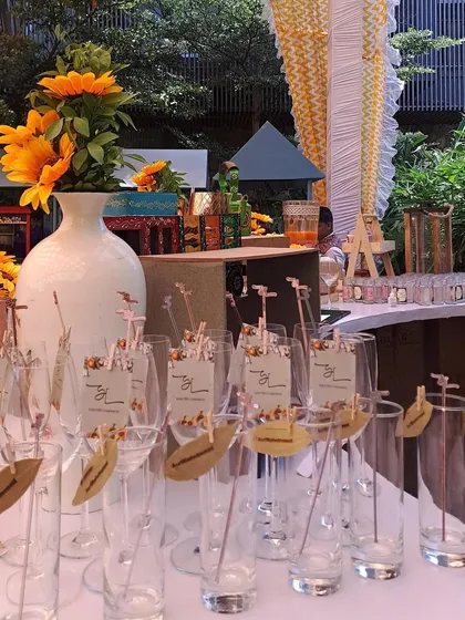 This sunflower-themed bar includes personalized stirrers and stamped leaf garnishes, bringing a sunny, rustic charm to the celebration.
