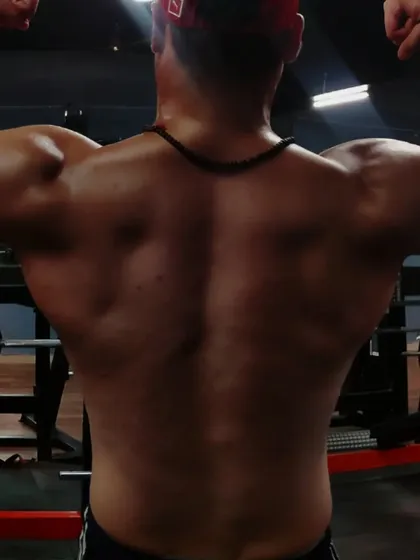 Progress is a journey. Here I'm assessing my lower back, identifying areas to improve. My coaching is transparent, and we will work together to cut fat and build muscle.
