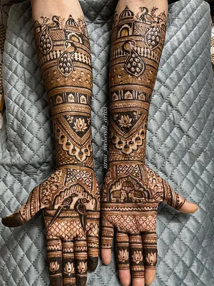 A gorgeous design for the mother of the bride. It's elaborate and beautiful, featuring peacocks and lotus motifs, but slightly less heavy than the bridal mehendi.