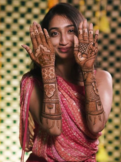 Another shot of the happy bride, her smile showing her delight with the beautiful, detailed mehendi.