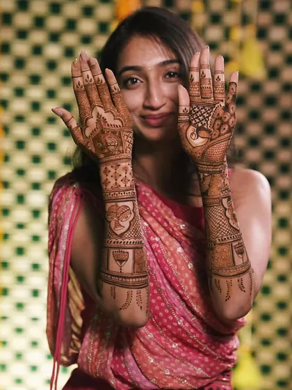 Another shot of the happy bride, her smile showing her delight with the beautiful, detailed mehendi.