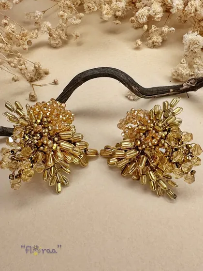All that glitters is gold. This classic pair of golden studs is the one-accessory solution for multiple outfits.