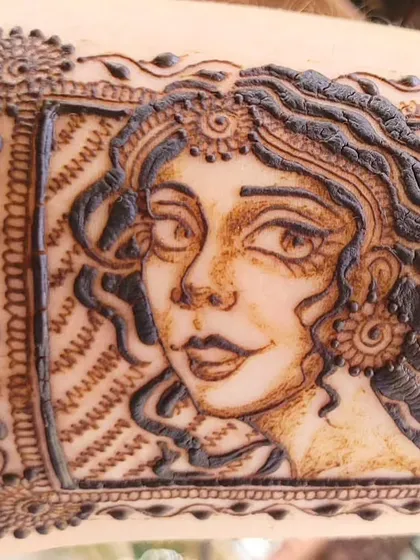 A closer look at the details of the portrait doodle, showing the fine lines in the hair and the delicate shading on the face.