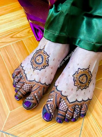 A unique foot design with a central lotus mandala, checkerboard patterns on the toes, and a delicate dotted pattern on the rest of the foot.