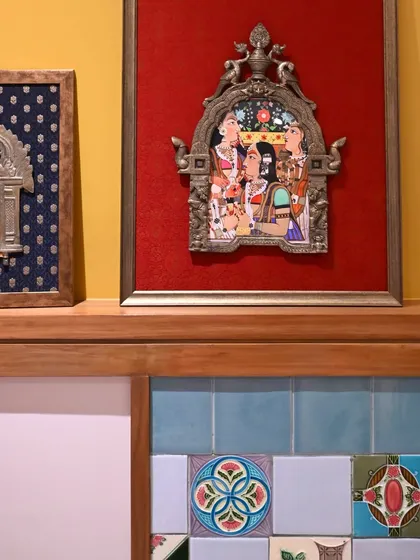 The set of two Prabhavalis displayed on a ledge, showing how they work together as a complementary pair. The contrast between the red and blue silks creates a dynamic visual story.