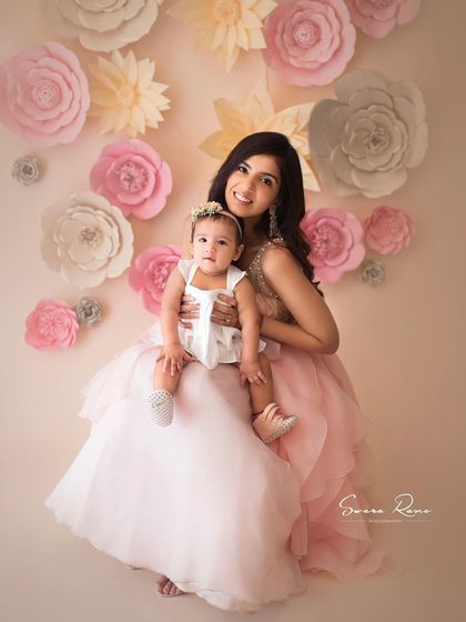 The gorgeous Nishka Lulla with her mini-me. The soft pink tones of the background, their outfits, and the paper flowers create a beautifully coordinated and elegant portrait.