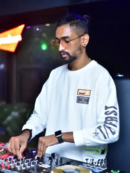 A candid shot of me focused on the mix during a Sunday special gig. I use professional-grade equipment to ensure every beat sounds crisp and powerful, delivering a premium audio experience.