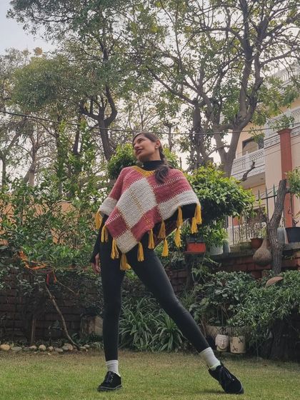 Wearing my finished #PenelovePoncho. It's so warm and stylish, perfect for layering over a turtleneck on a chilly day. The tassels add a fun, playful touch.