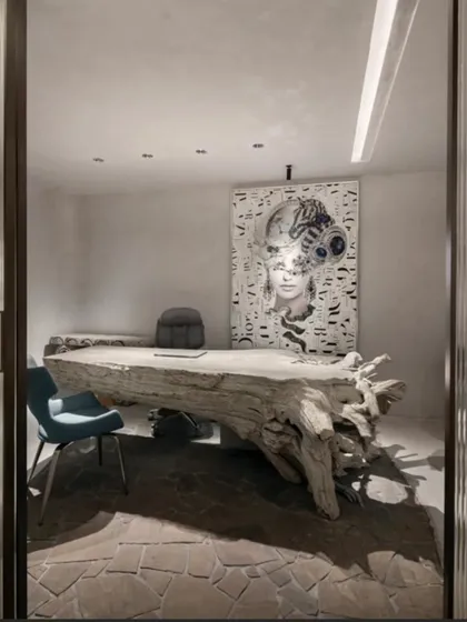 This private office within the showroom features a desk carved from a massive reclaimed wood log. It’s a bold statement of identity, turning natural materials into functional art and reshaping the idea of a luxury workspace.
