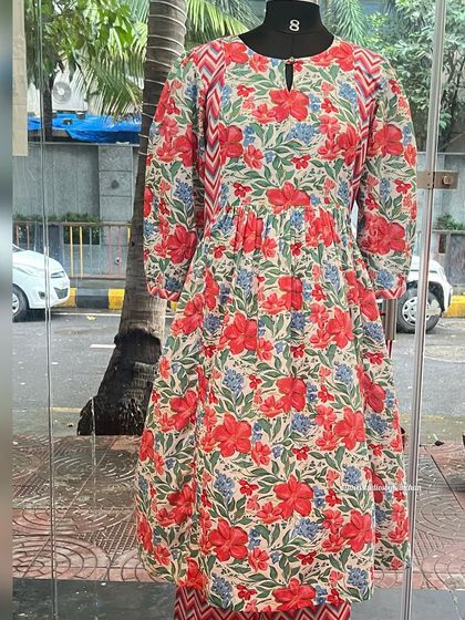 A closer look at our festive red floral printed kurta on a mannequin. This pure cotton piece is designed to help you celebrate in style.