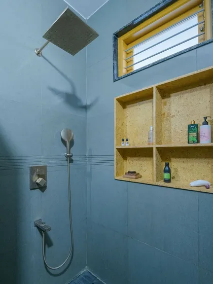 Another view of the shower, highlighting the practical and beautiful sandstone niche for storage.