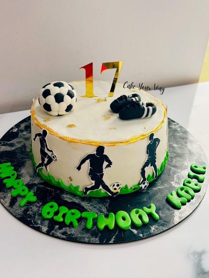 A goal-worthy cake for a 17th birthday, featuring soccer player silhouettes and a fondant ball.