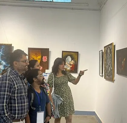 An art enthusiast pointing out details in one of my paintings.