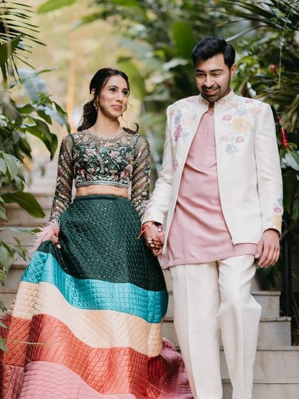A beautiful shot of the couple walking hand-in-hand.