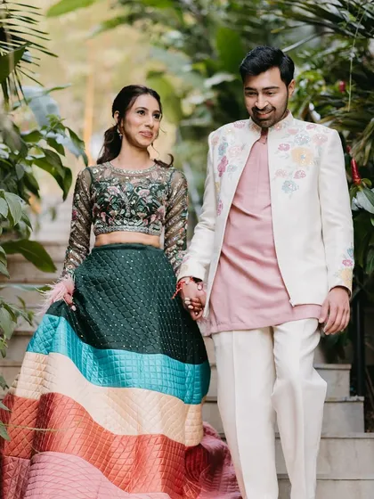 A beautiful shot of the couple walking hand-in-hand.
