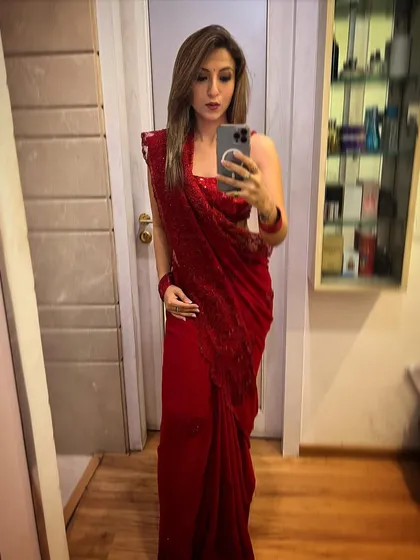 A mirror selfie in a beautiful red saree. I love the elegance and grace of traditional Indian attire.