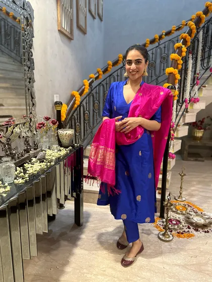 A classic festive look featuring a royal blue silk kurta with a vibrant pink Banarasi dupatta. This color combination is a guaranteed head-turner.