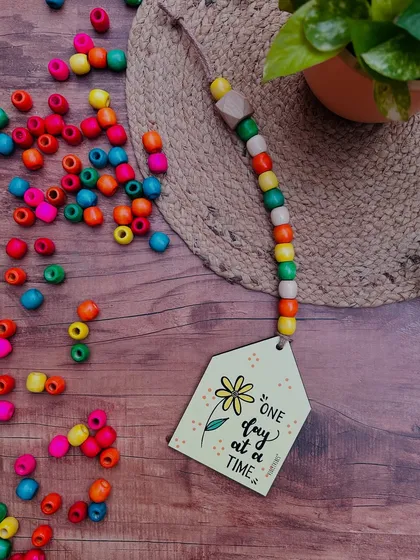 Our 'One Day at a Time' beaded hut is a gentle reminder to take things slow. This hand-doodled piece with colorful beads is a thoughtful and beautiful addition to any small corner.