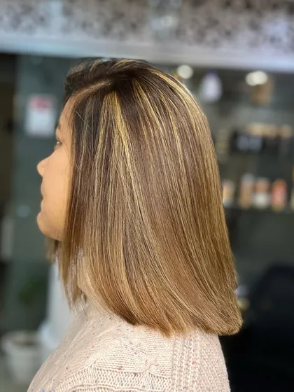 A chic bob with warm blonde highlights. This is a great example of how color can elevate a classic haircut.