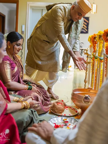 Capturing the traditional rituals of a home wedding ceremony, with family members taking part in the blessings.