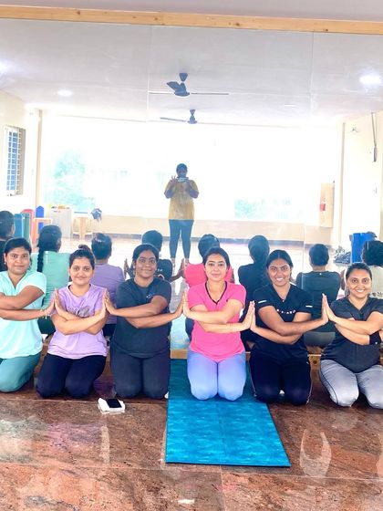 A group of students kneeling in a pose that symbolizes unity and shared intention. The smiles and focused energy are what make our community so special.