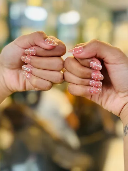 A close-up of the sheer polka dot nails, demonstrating how this subtle art can elevate a natural manicure.