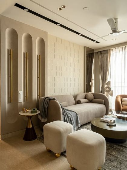 Neutral, but never boring. This living room blends calm tones with bold furniture accents for the perfect pop. The seamless textures and material mix bring depth and quiet drama, from the HDHMR paneling to the bespoke wall light.