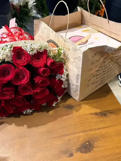 I can easily combine your flower order with a fresh cake for a complete celebration package. This is a red rose bouquet ready to be delivered with a birthday cake in Ghaziabad.