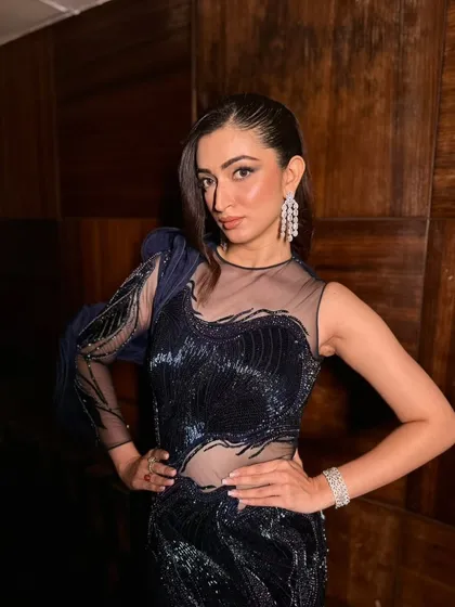 A confident pose showing off the full cocktail look. The makeup is designed to be flawless and long-lasting, ensuring she looks perfect all night.