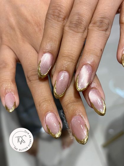 A full view of the elegant cat-eye nails with a gold chrome French tip. This is a popular choice for festive occasions and weddings.