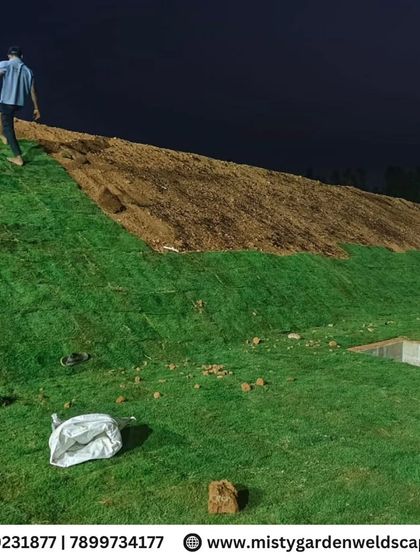 Another shot of the lawn installation on a slope, showing the scale of the project and the methodical approach we take.